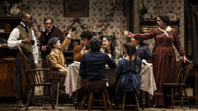 ACC_8 The Cratchits toast to Scrooge while he looks on