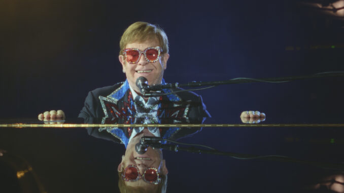 sej1v_aq0359_credit_this_machine_96114e8f Elton John at the piano